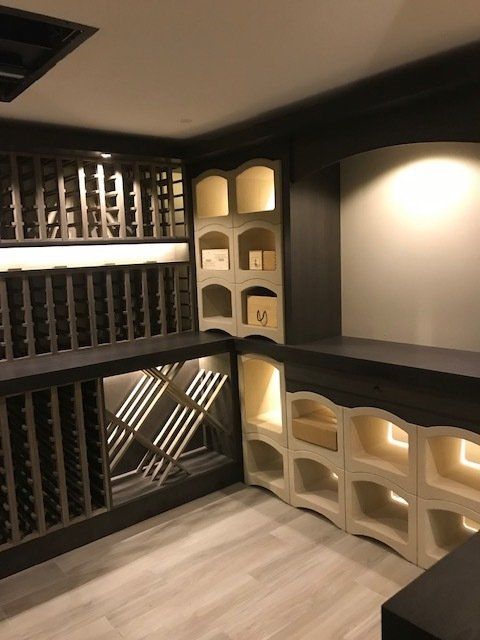 A wine cellar with lots of shelves and bottles