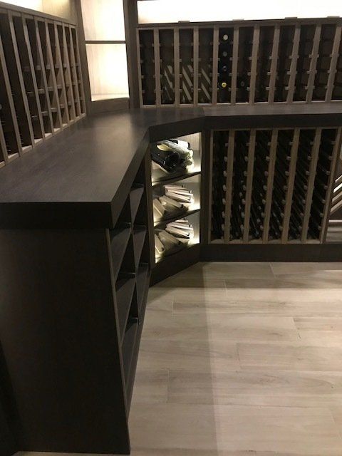 A wine cellar with lots of shelves and bottles of wine.