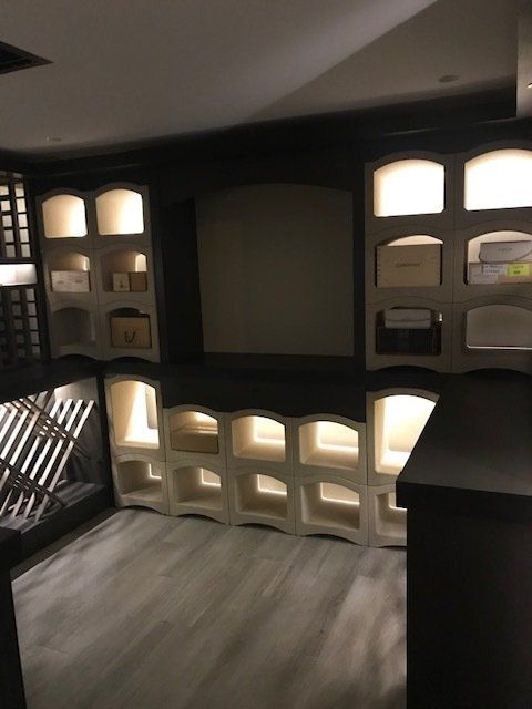 A room with a lot of shelves and lights on