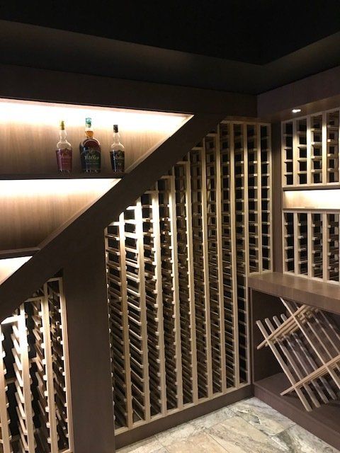 A wine cellar with lots of wine bottles on shelves