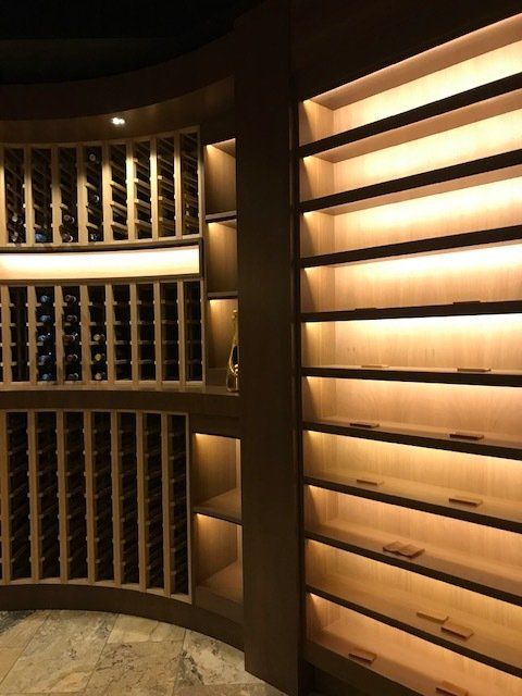 A wine cellar with lots of shelves and bottles