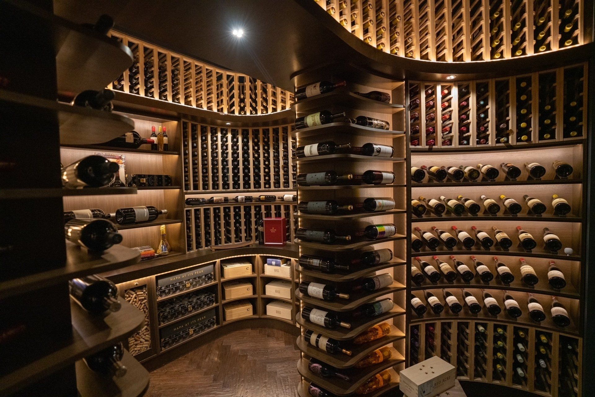 A large wine cellar filled with lots of bottles of wine.