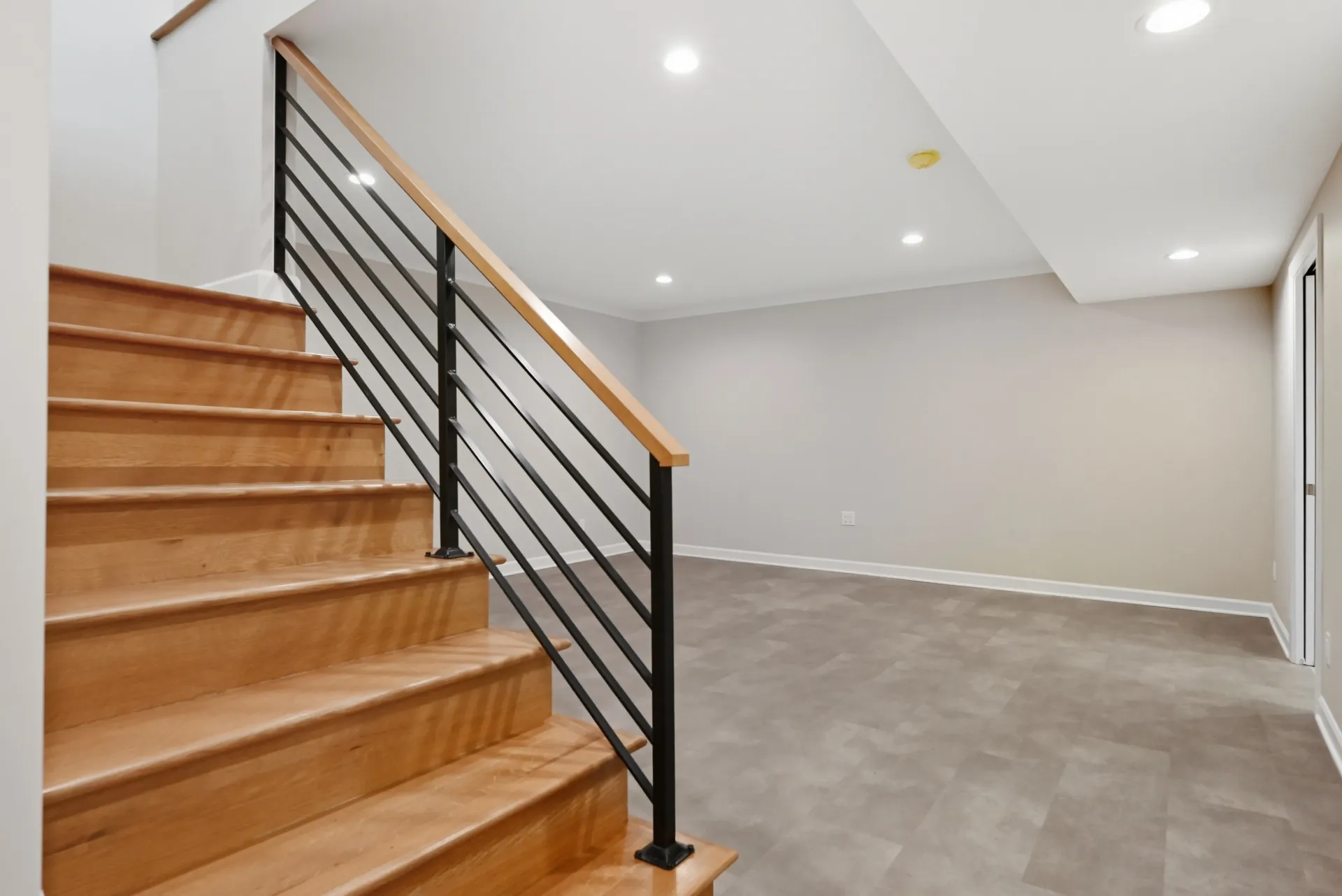 A large brick house with a black garage door - Omaha, NE - BluePrint Construction