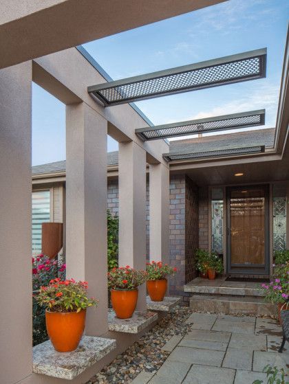A row of potted plants in front of a house - Omaha, NE - BluePrint Construction