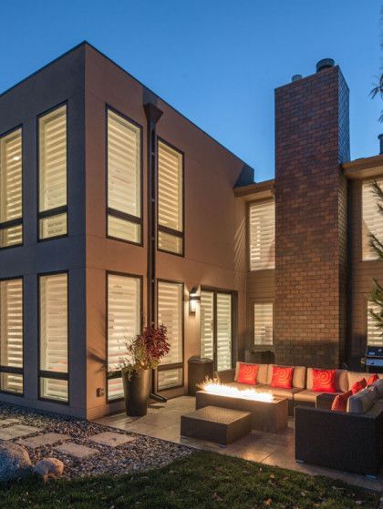 A large house with a lot of windows and a fire pit - Omaha, NE - BluePrint Construction