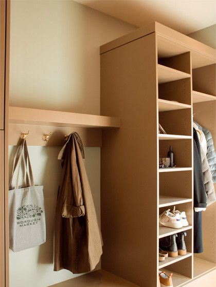 A closet with a coat hanging on a hook and a bag - Omaha, NE - BluePrint Construction