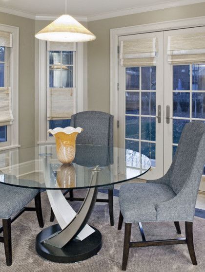 A dining room with a glass table and chairs - Omaha, NE - BluePrint Construction
