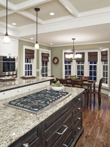 A kitchen with a large island and a stove top oven - Omaha, NE - BluePrint Construction