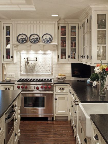 A kitchen with stainless steel appliances and white cabinets - Omaha, NE - BluePrint Construction