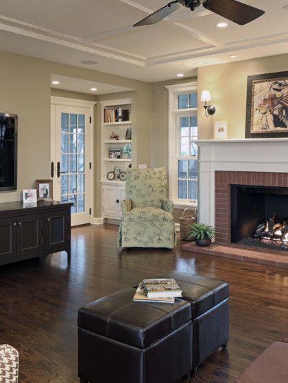 A living room with a fireplace and a ceiling fan - Omaha, NE - BluePrint Construction
