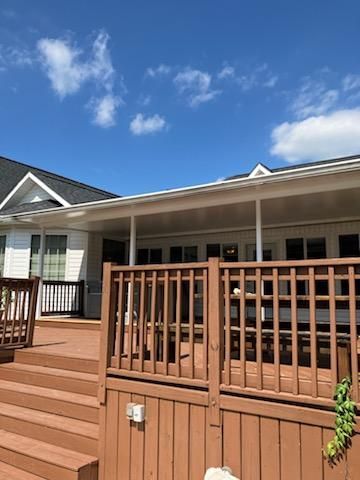 There is a patio with a table and chairs and an umbrella — Greenville, SC — Greenville Aluminum