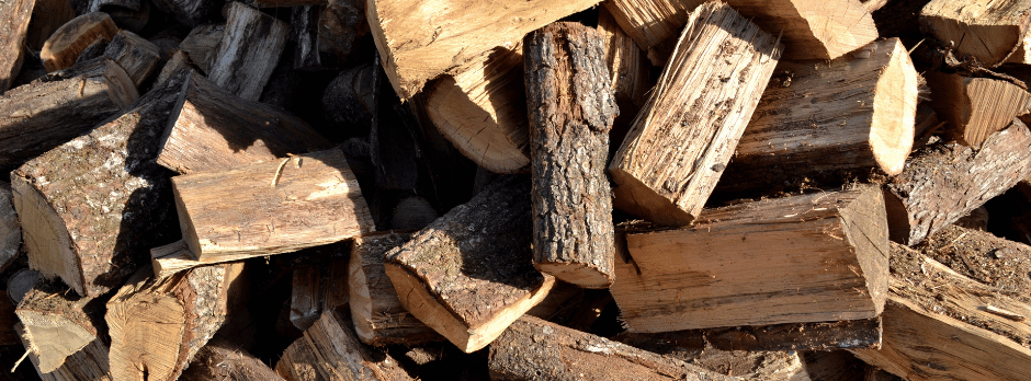 A pile of chopped wood is sitting on top of each other.