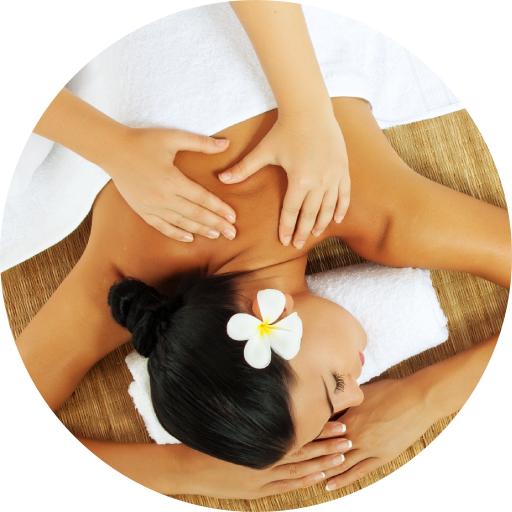A woman with a flower in her hair is getting a massage