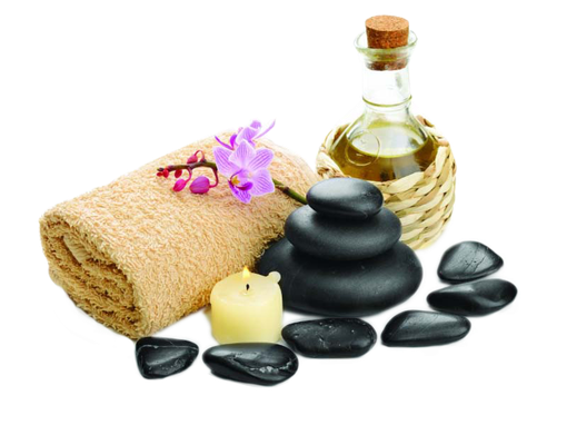 A towel , a bottle of oil , a candle , and black rocks on a white background.