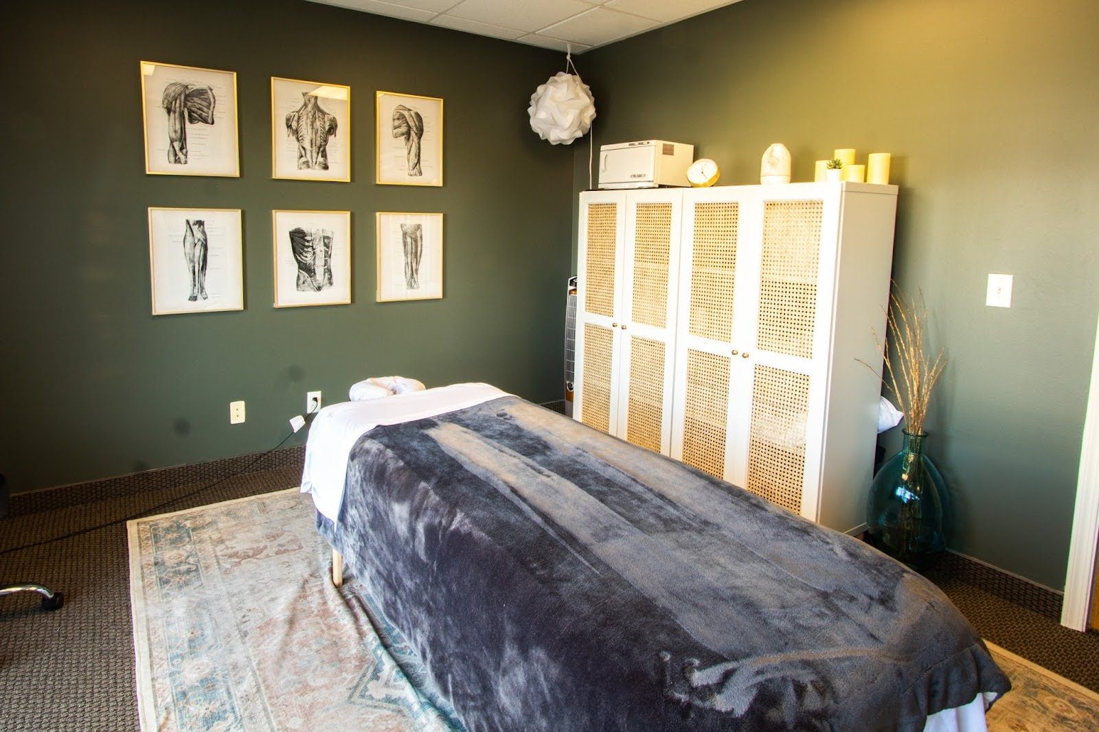 There is a massage table in the middle of the room.