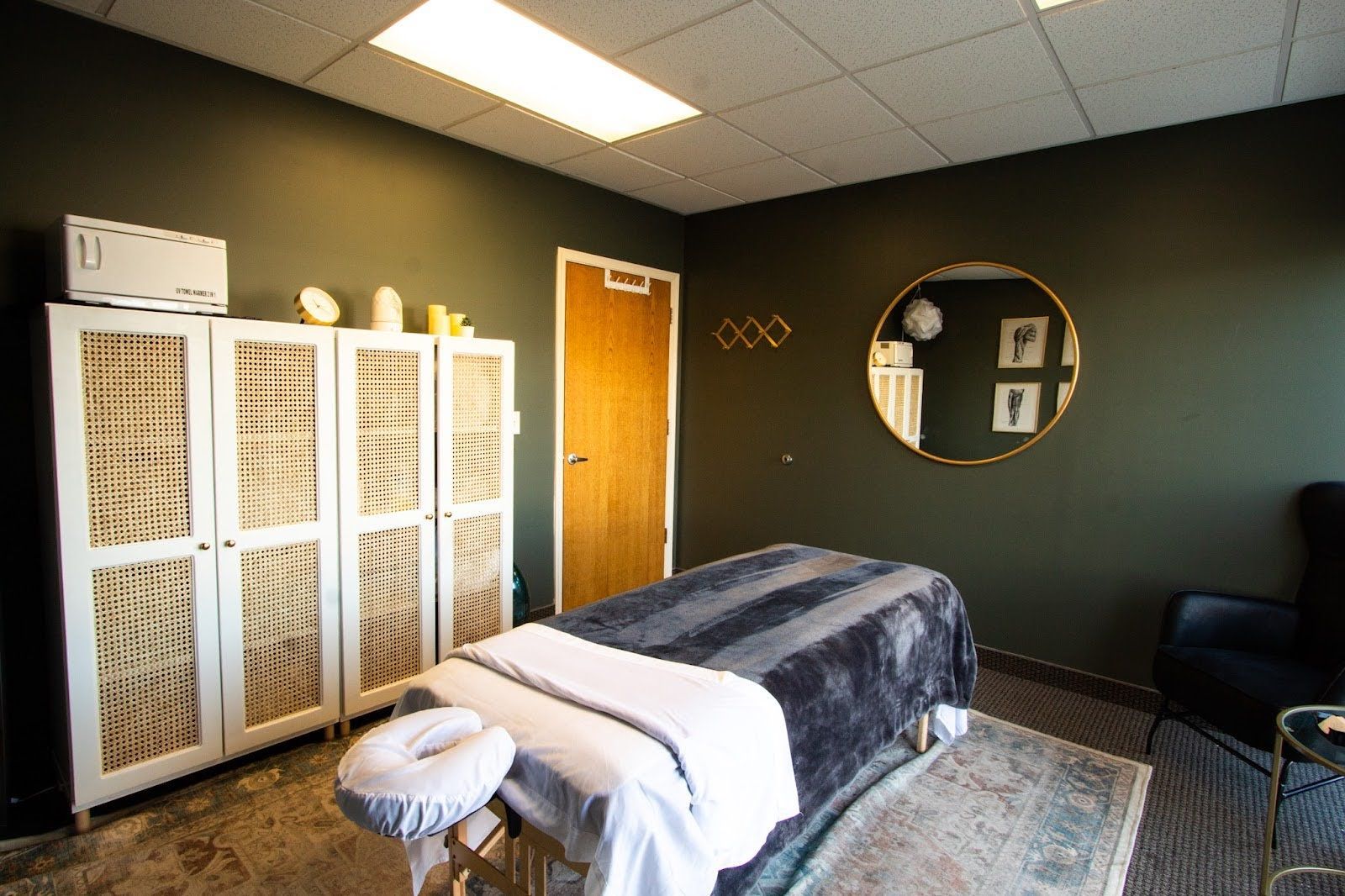 There is a massage table in the middle of the room.