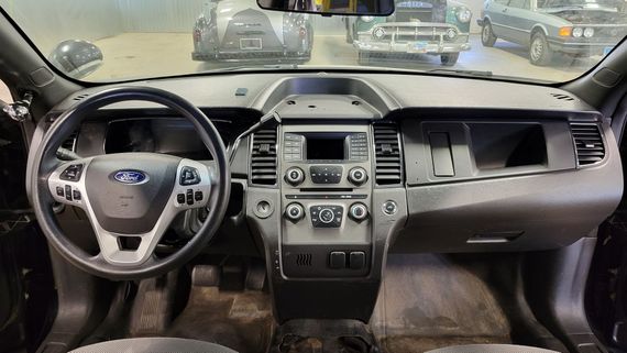 The interior of a ford police car is shown.