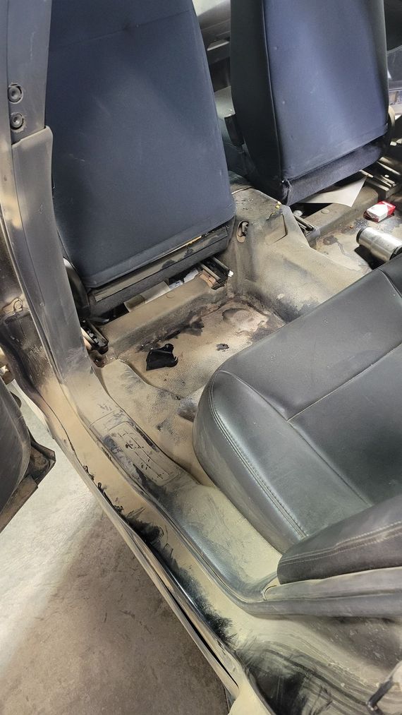 The seats of a car are covered in dust and dirt.