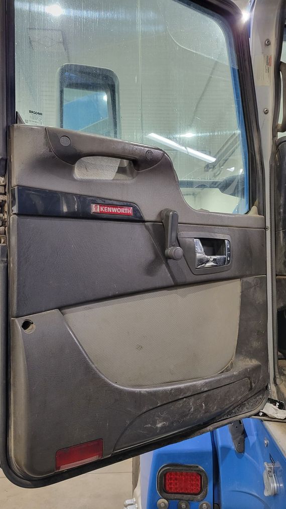 A close up of a truck door with the door open.
