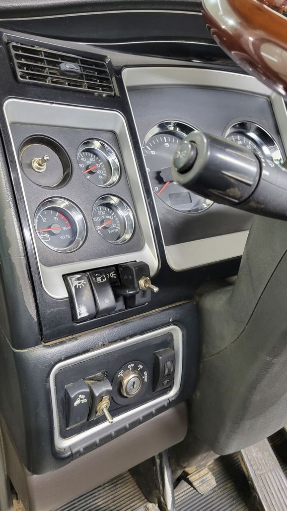 A close up of a car dashboard with a steering wheel.