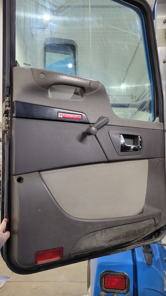A close up of a door on a truck with the door open.
