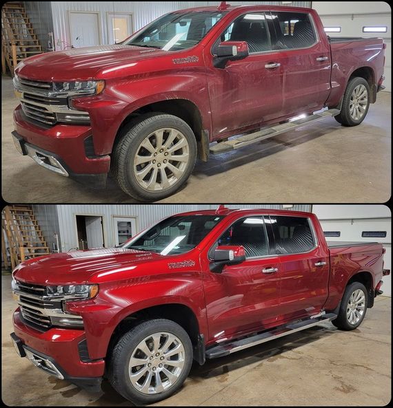 A red truck is sitting in a garage before and after being cleaned.