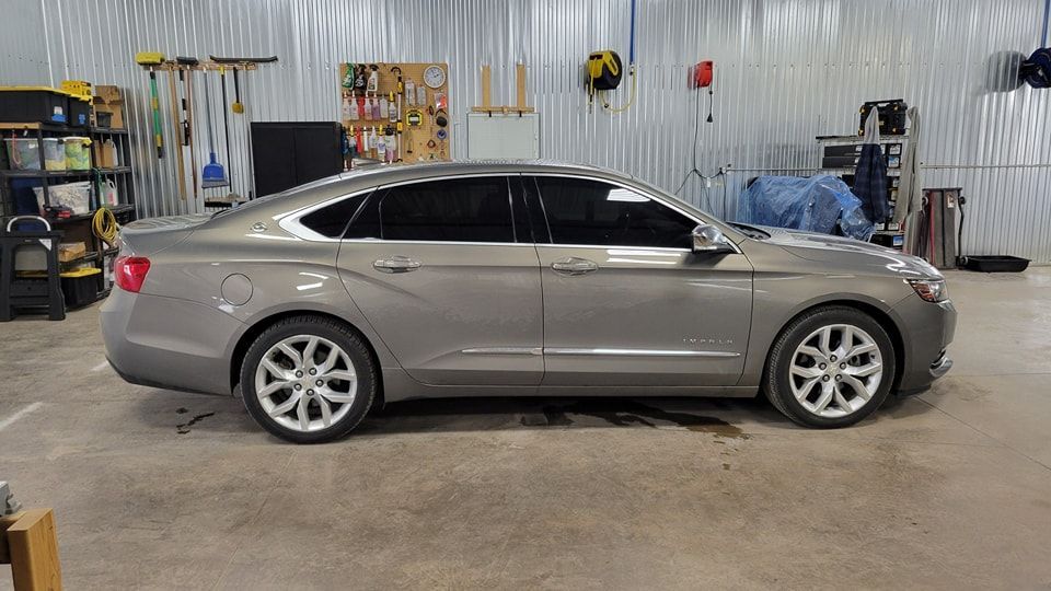 A silver car is parked in a garage.