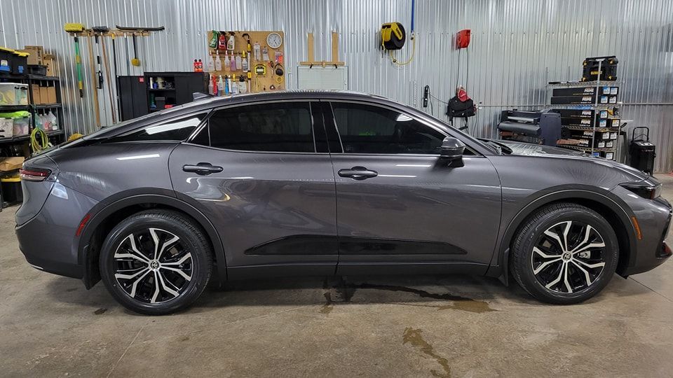 A gray car is parked in a garage.