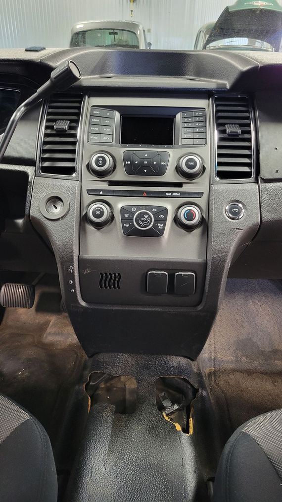 The dashboard of a car is dirty and needs to be cleaned.