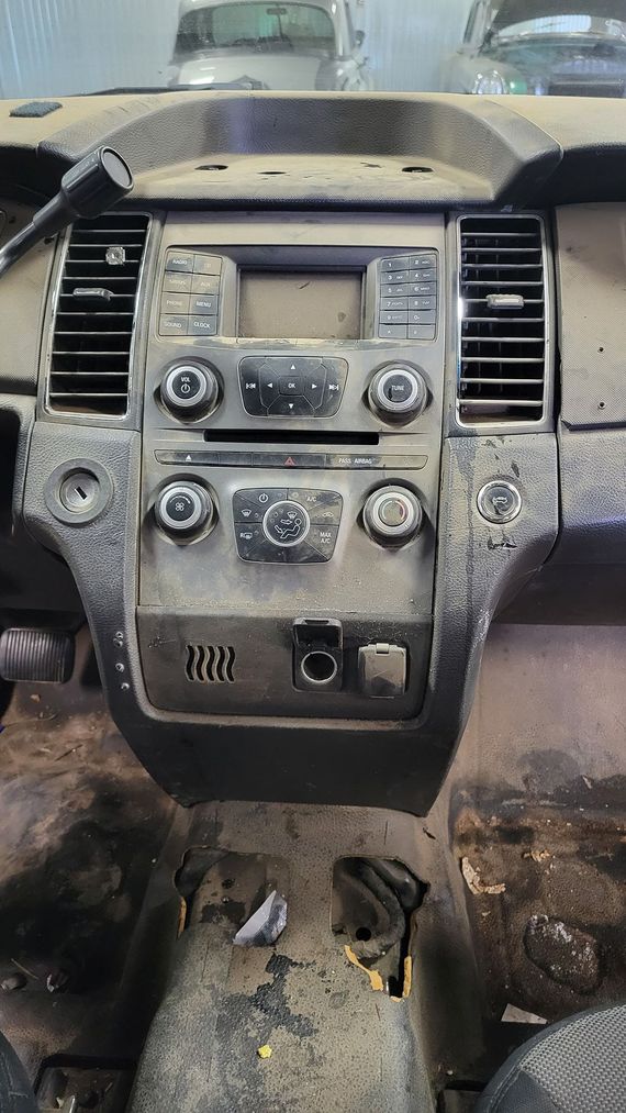 The dashboard of a car is dirty and needs to be cleaned.