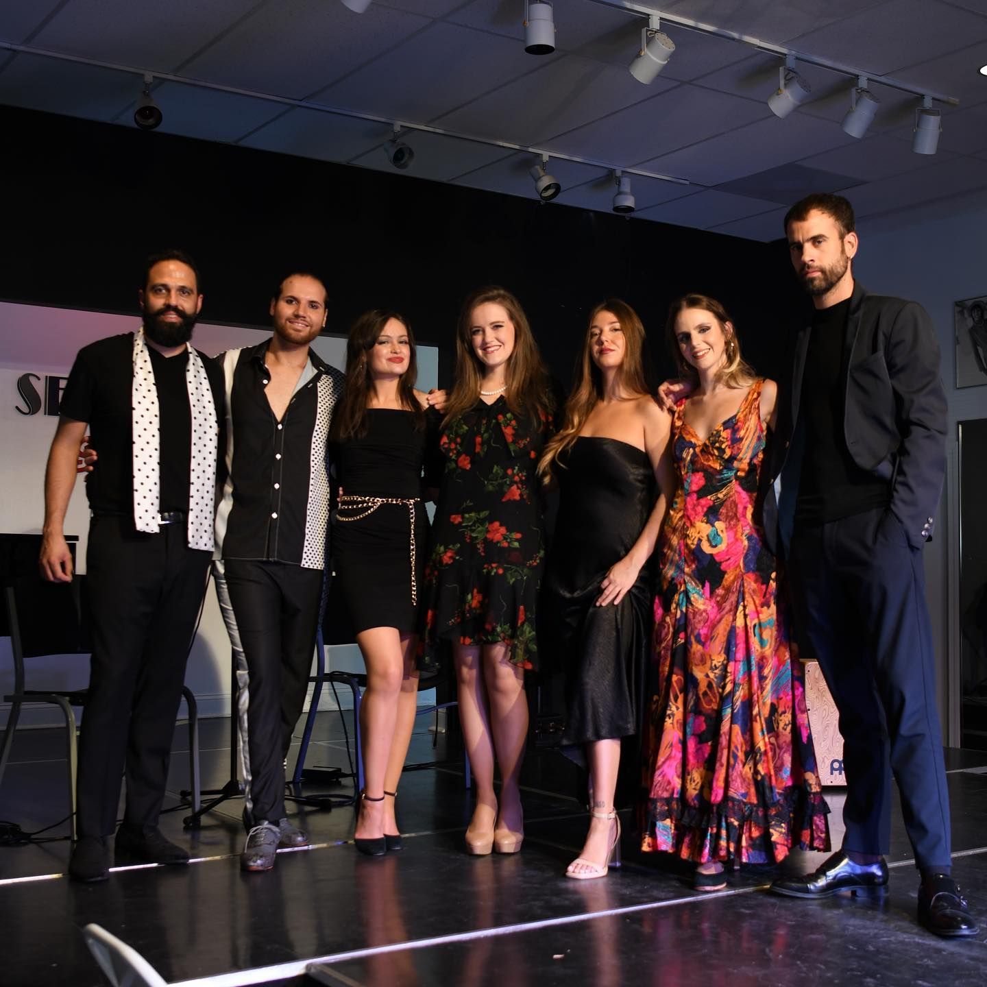 A group of people posing for a picture on a stage