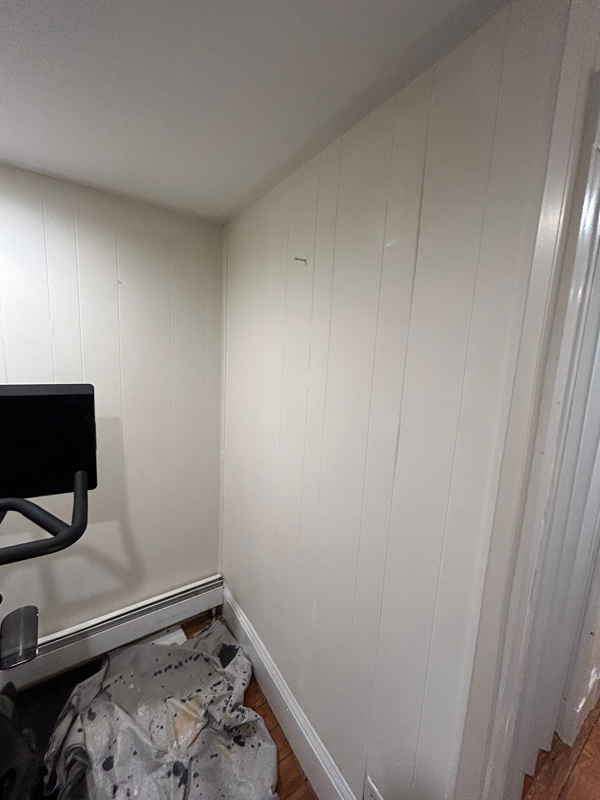 There is a treadmill in the corner of the room.