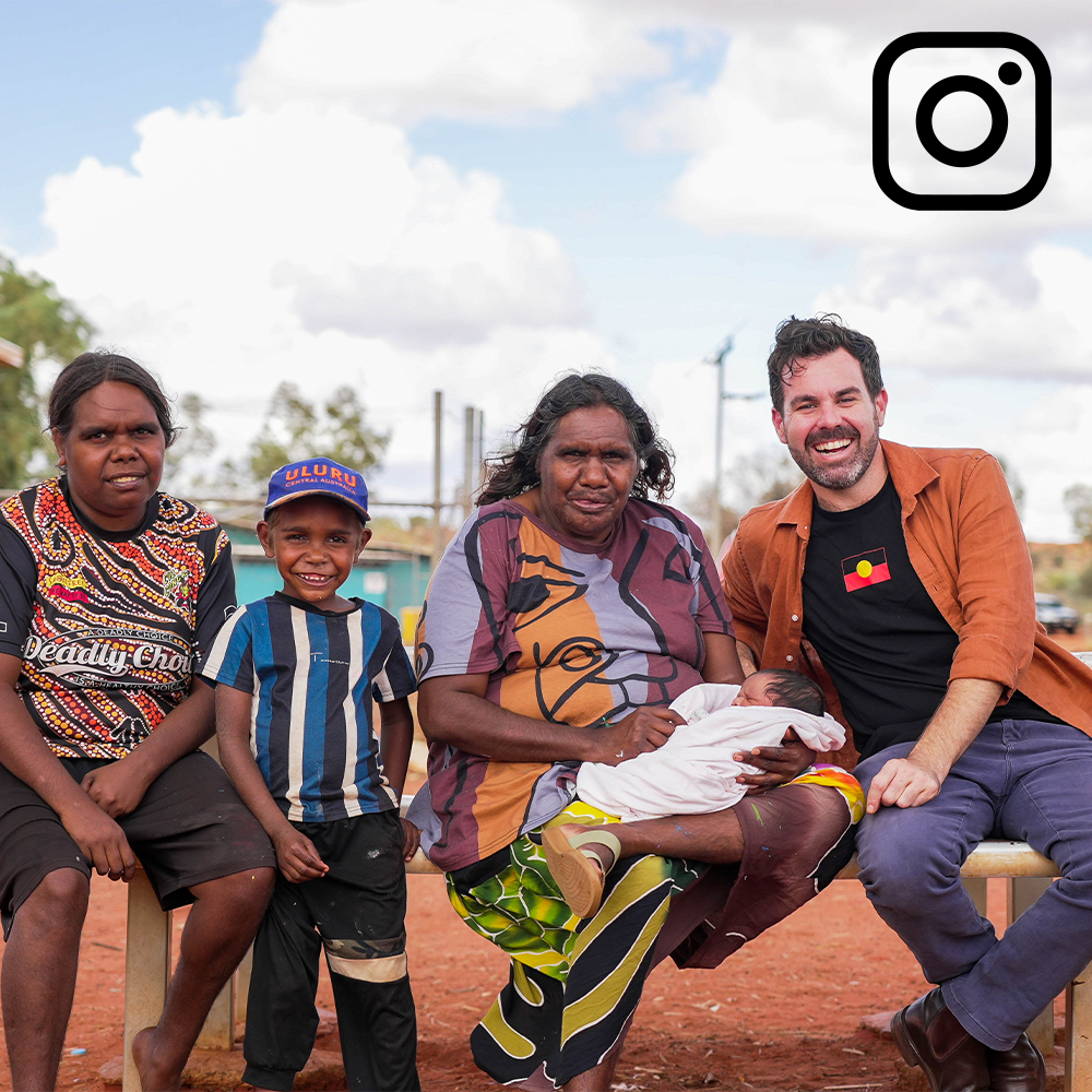 A group of people, including Indigenous Australians, smile for a photo outdoors. Instagram logo in the corner.