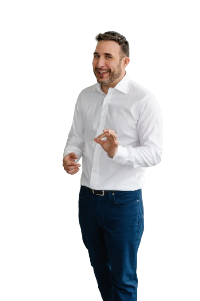 Un homme en chemise blanche et jean bleu se tient devant un fond blanc.