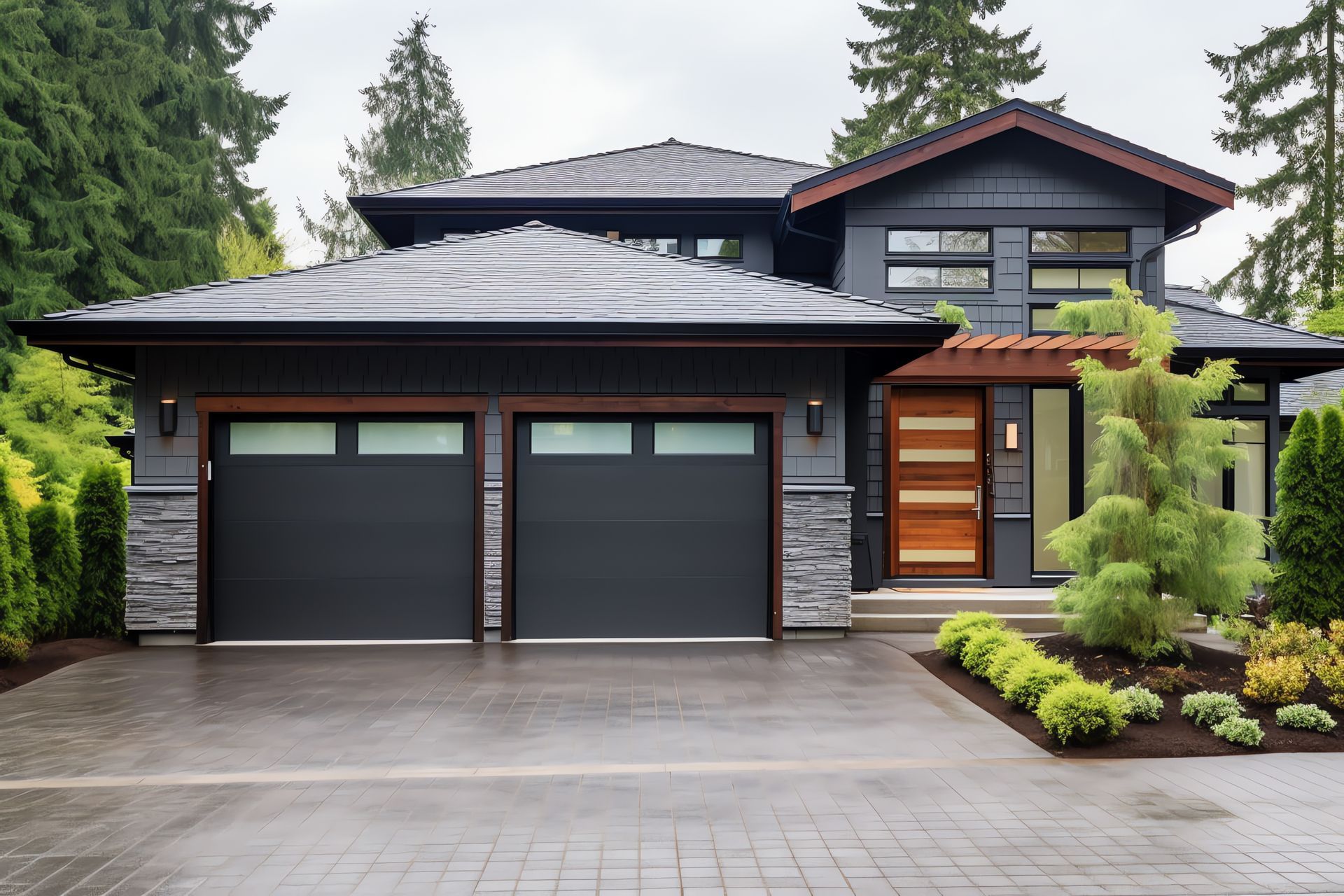 A large house with two garage doors and a driveway