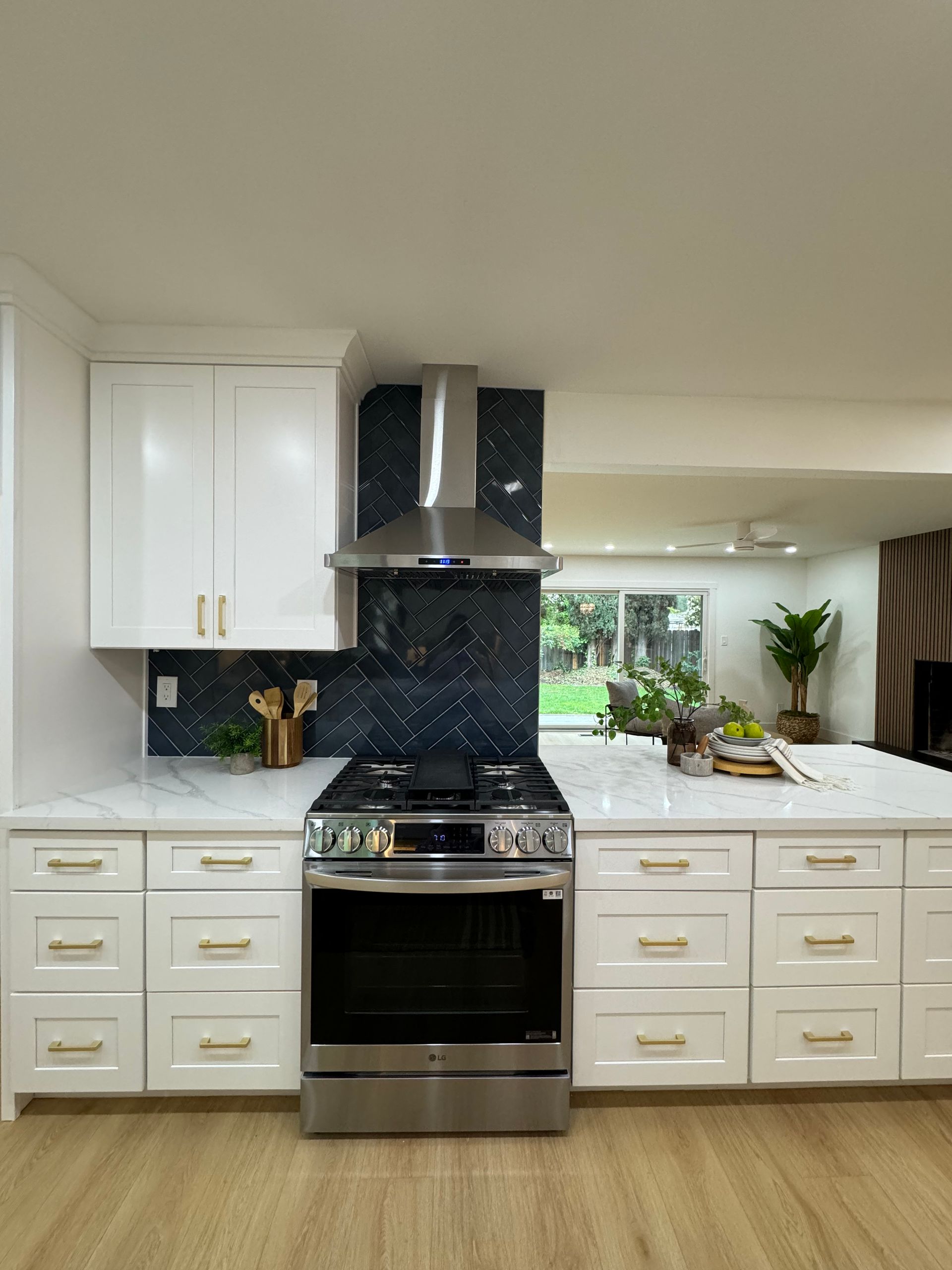 A kitchen with stainless steel appliances and white cabinets.