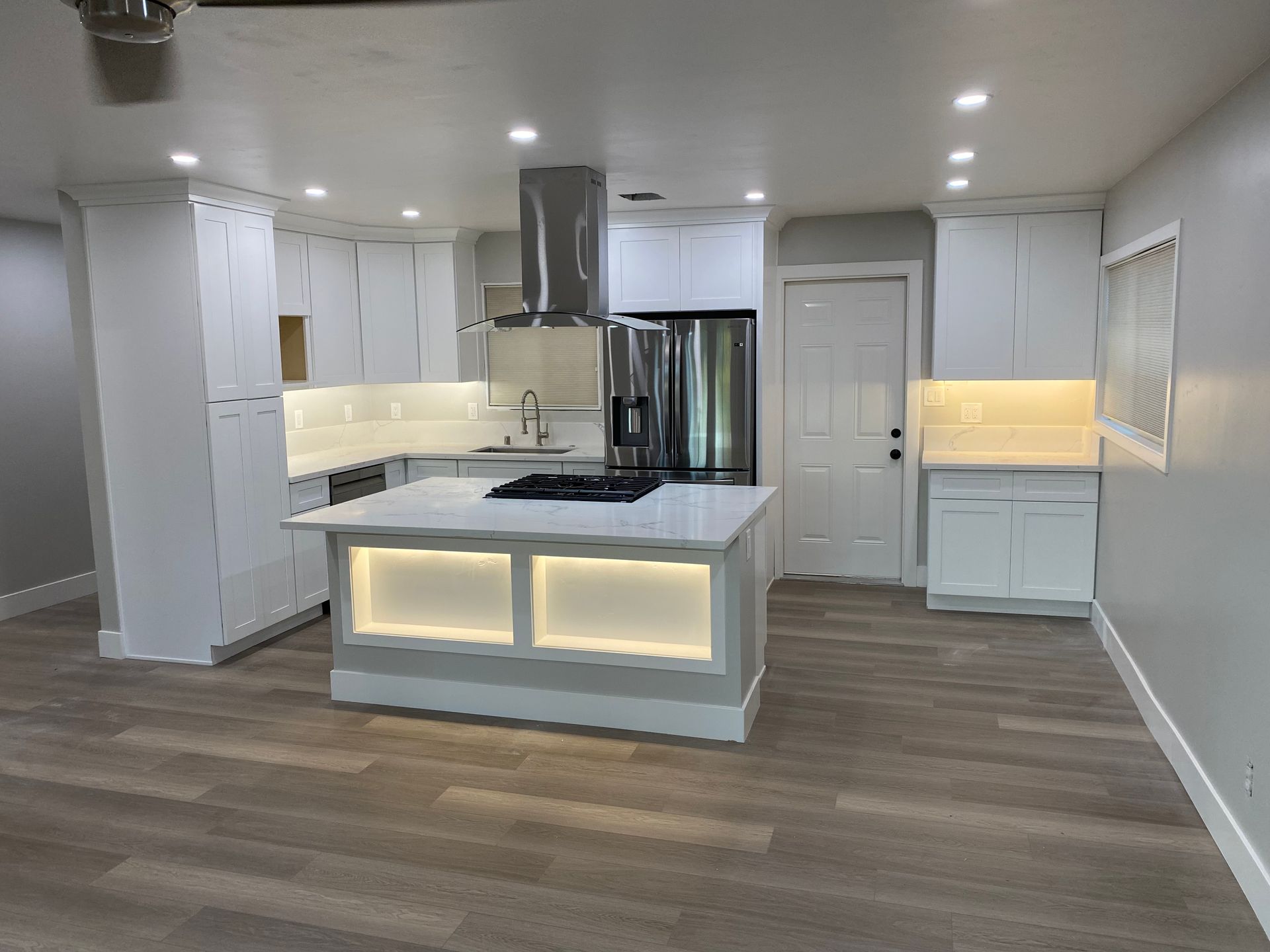 A kitchen with a large island in the middle of the room.