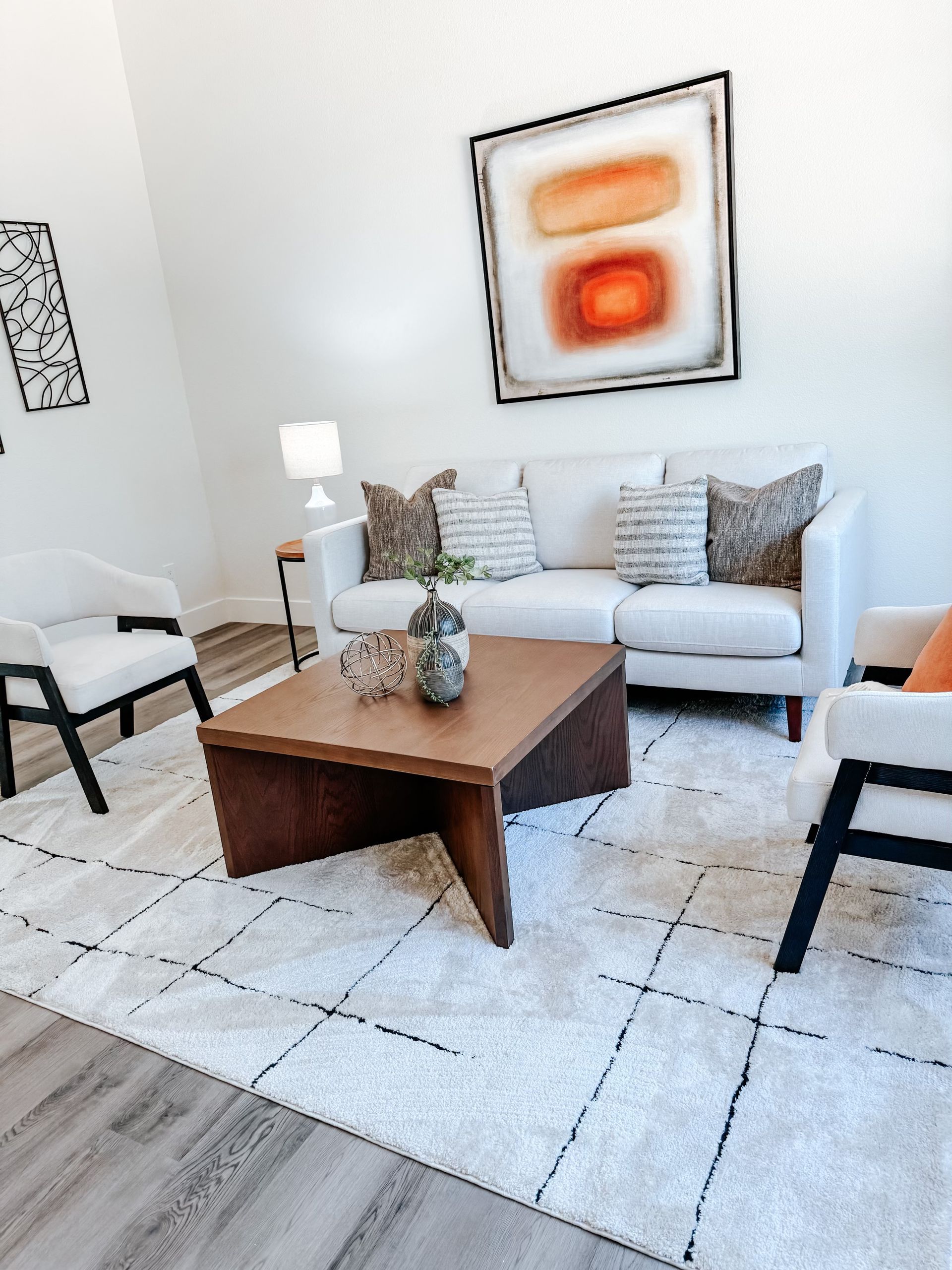 A living room with a couch , chairs and a coffee table