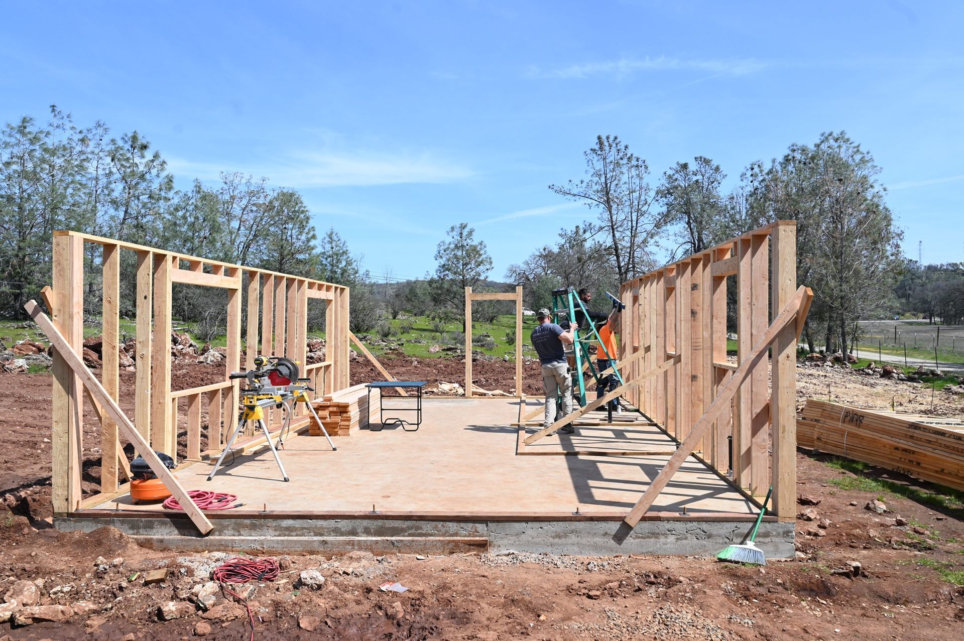 A group of people are working on a wooden structure.