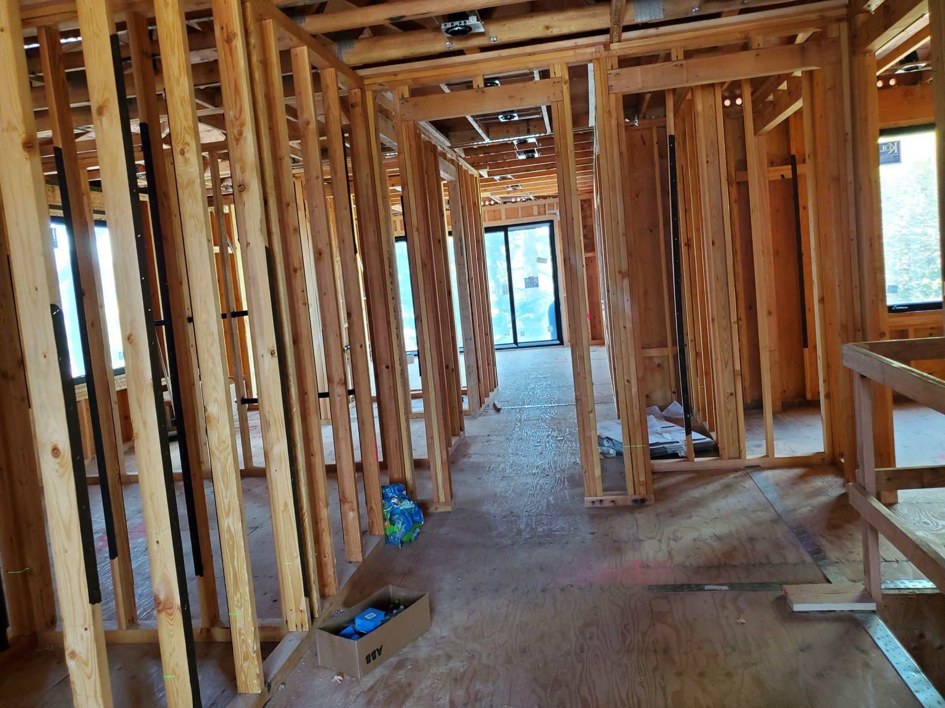 Interior view of a residential renovation featuring a steel support beam, exposed brick, and a curved staircase. Interior view of a residential renovation featuring a steel support beam, exposed brick, and a curved staircase.