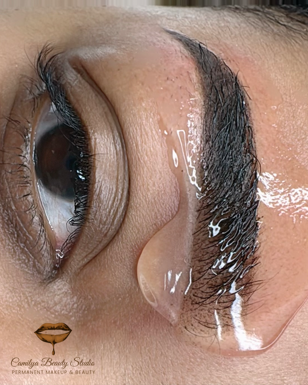 woman getting a permanent makeup treatment on her eyebrow