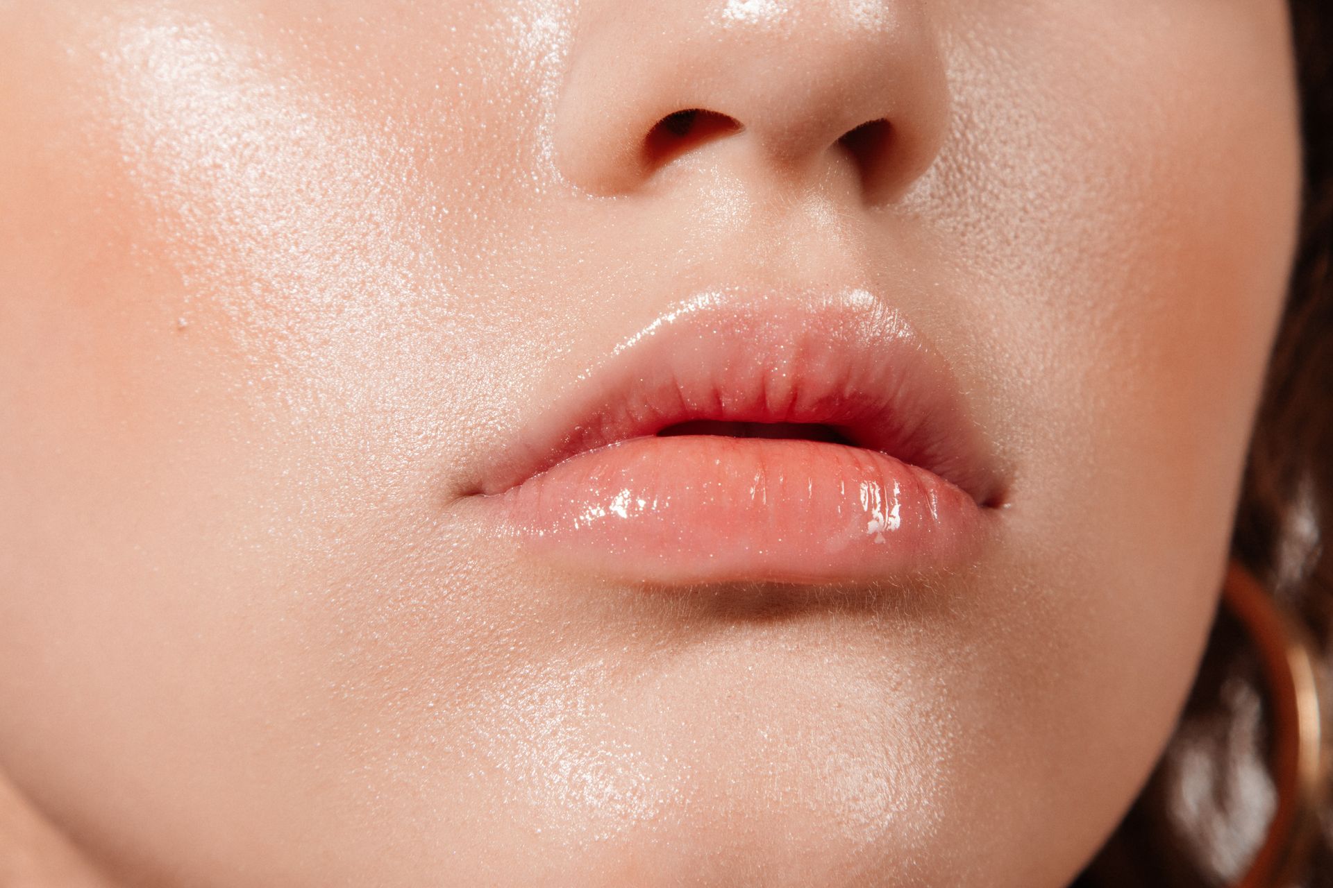 a close up of a woman 's lips with a glossy finish .