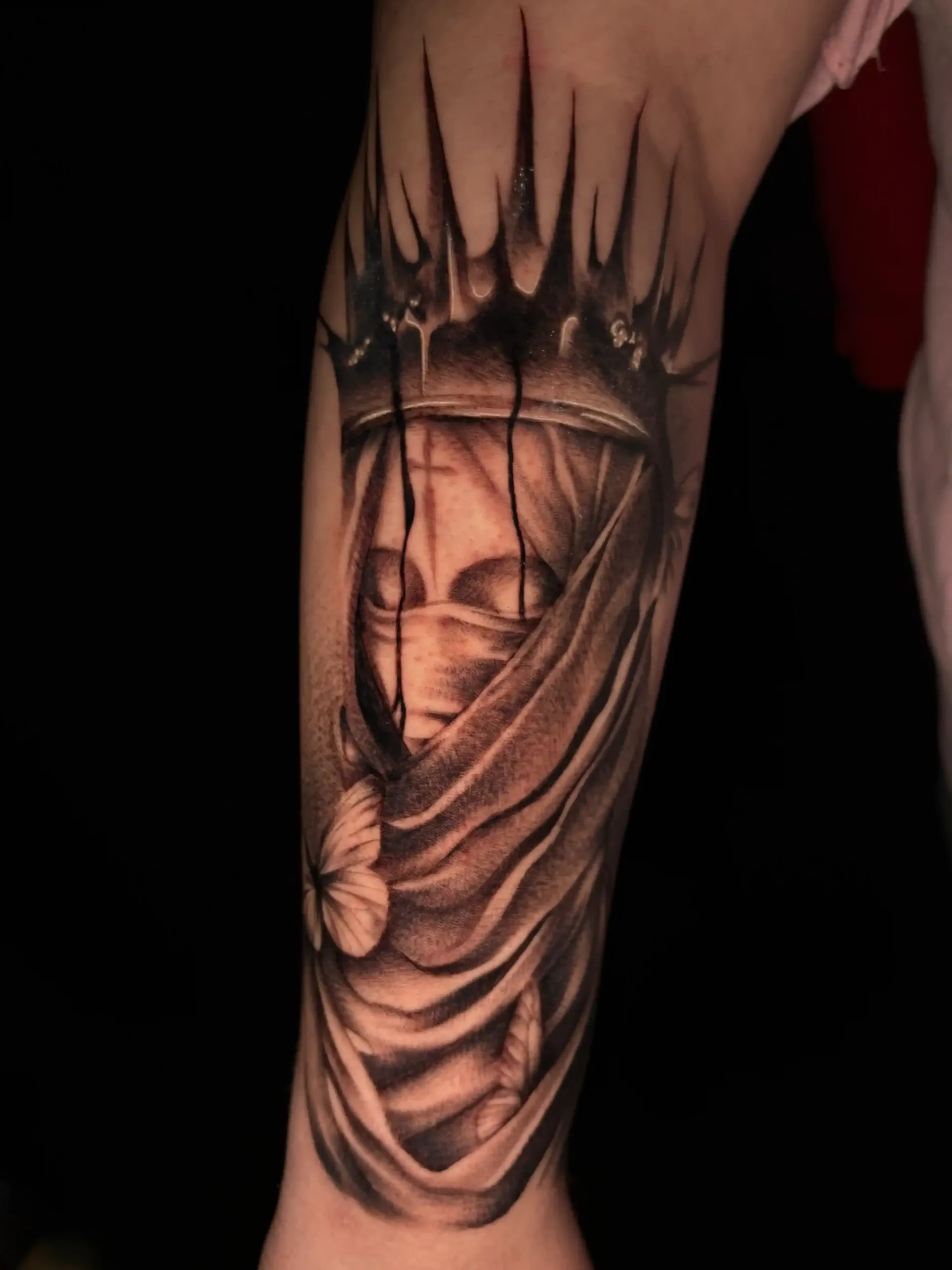 Black and grey realism tattoo of a veiled crowned figure by Savana Rodriguez at Black Rhino Tattoos Las Vegas