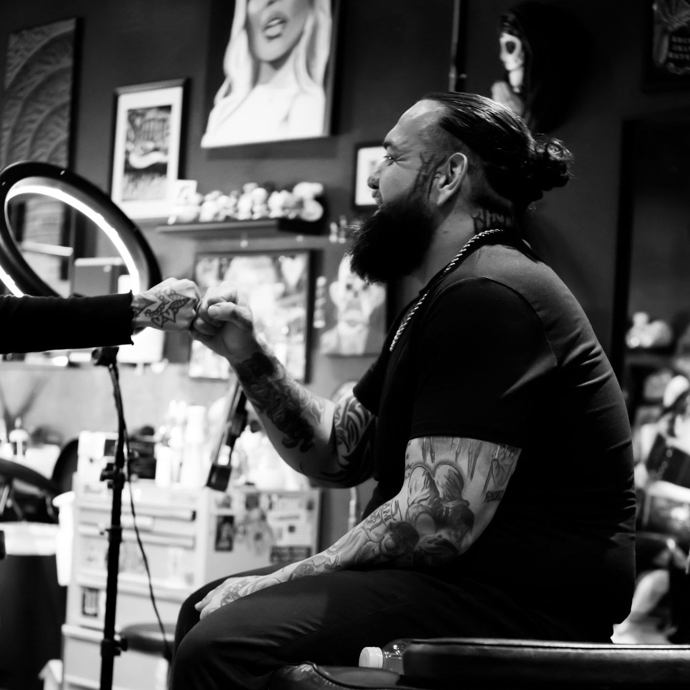 picture of Black Rhino Tattoos owner and tattoo artist, Igor Montano, fist bumping someone 