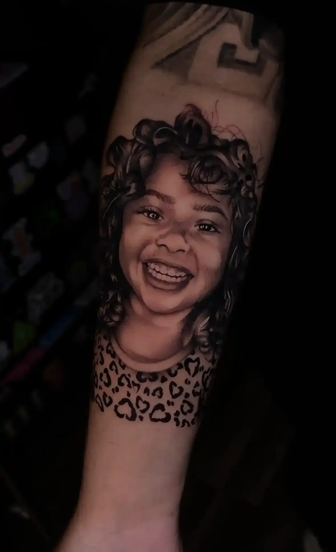Black and grey portrait tattoo of a young girl by Savana Rodriguez at Black Rhino Tattoos in Las Vegas