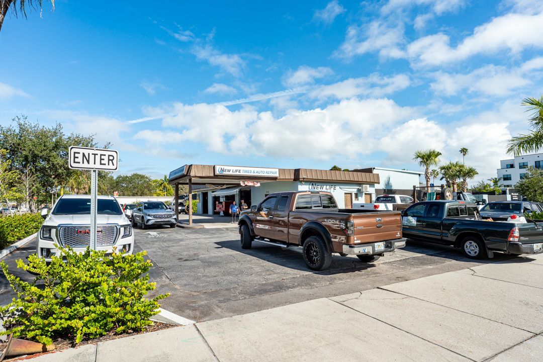 Cars at a drive-through car wash under a blue sky, with an 