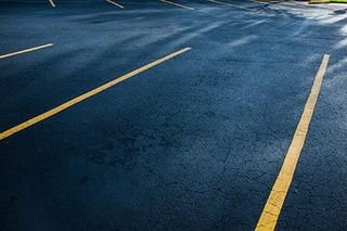 Parking Lot with Yellow Line — Line Stripping Services in Burlington, VT