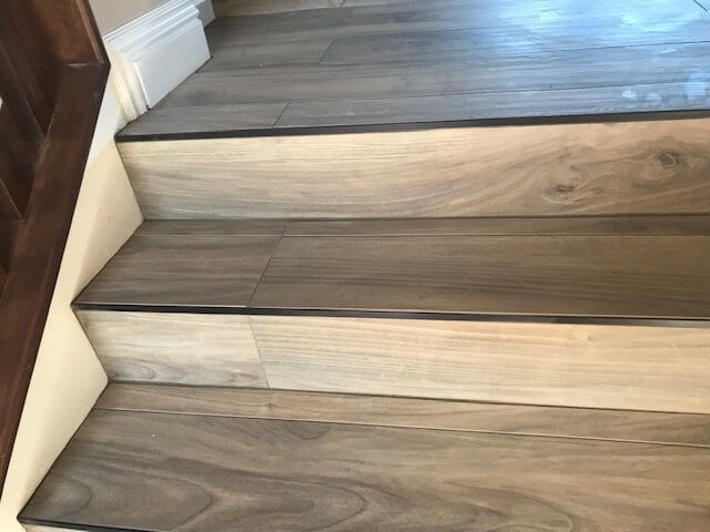 A set of stairs made of wood and tile