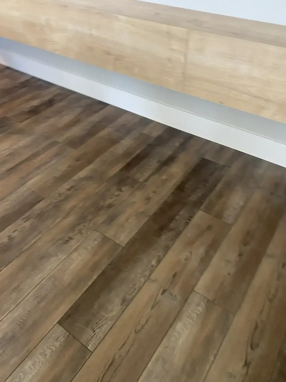 A close up of a wooden floor in a room.