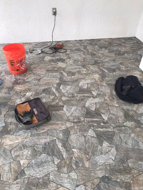 There is a bucket and a bag on the floor.